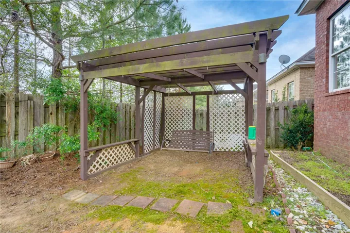 A tranquil pergola offers an ideal spot for outdoor relaxation and enjoyment.