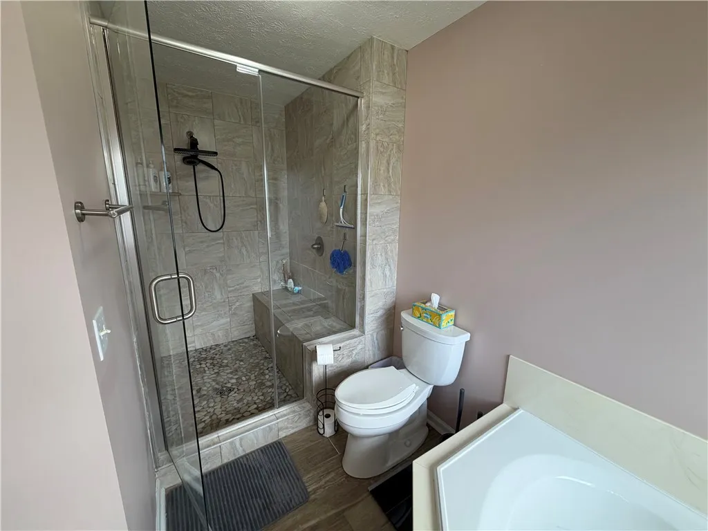 This bathroom features a sleek glass-enclosed shower, offering a modern and functional design.