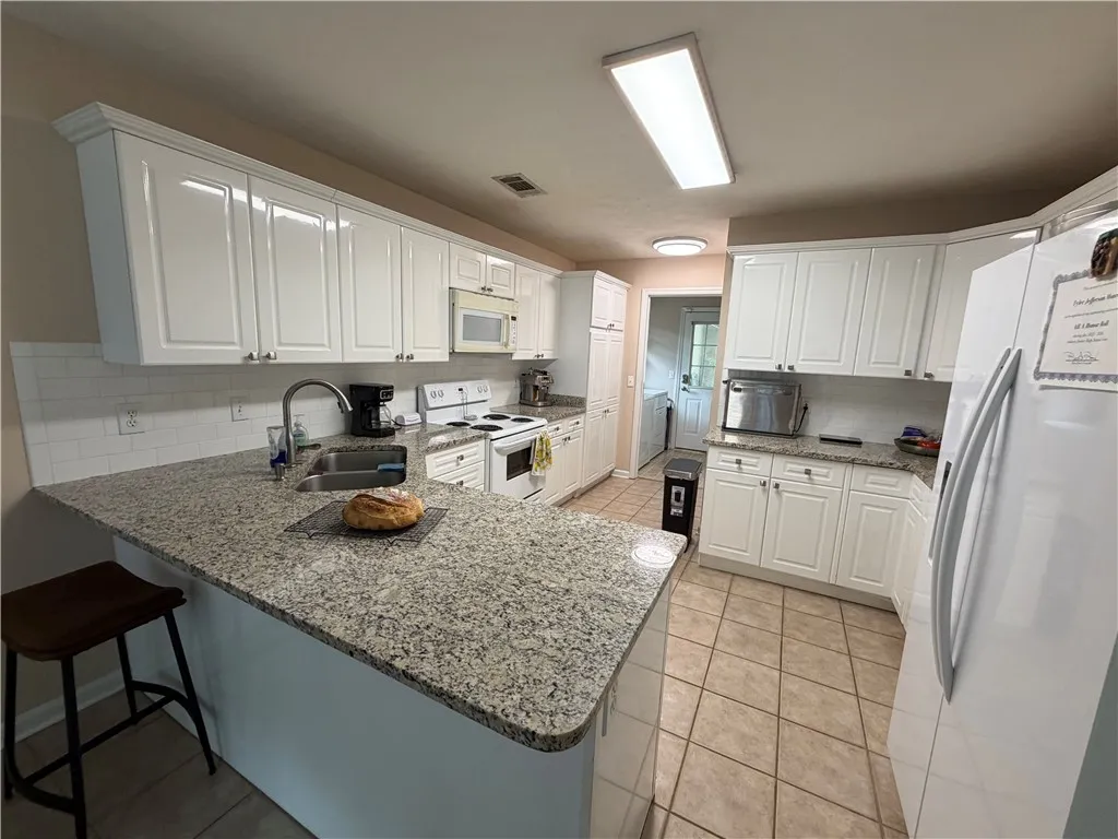 Bright and inviting kitchen with ample counter space and modern appliances.