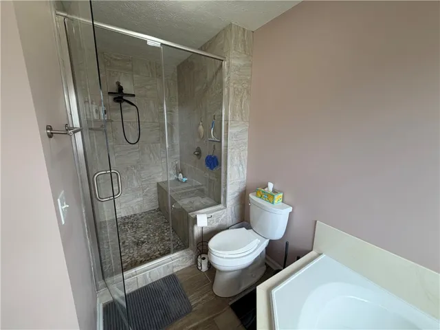 This bathroom features a sleek glass-enclosed shower, offering a modern and functional design.