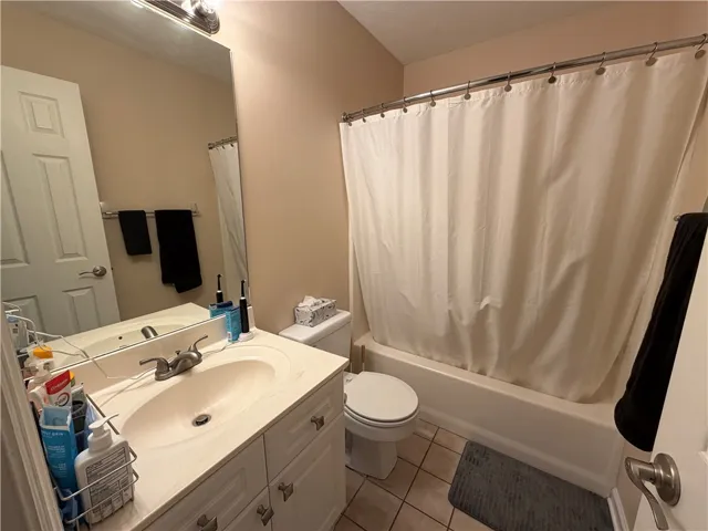 This bright bathroom features practical fixtures and classic tiling.
