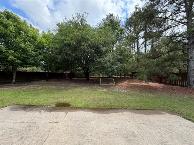 This spacious yard offers a serene backdrop for outdoor living.
