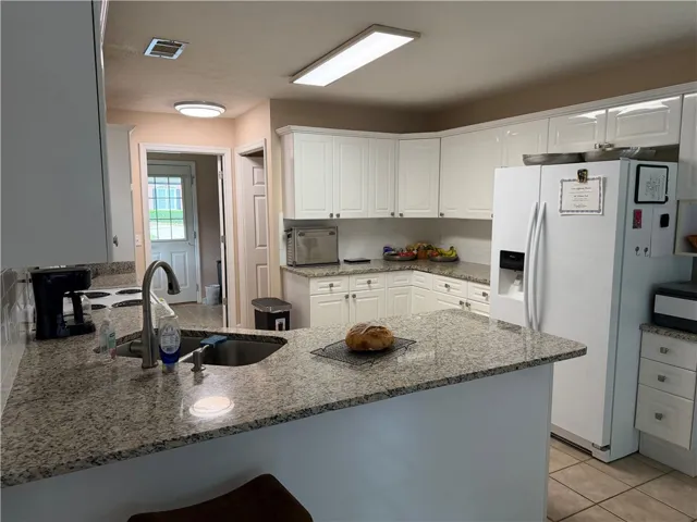 This bright kitchen features ample counter space, making it perfect for culinary endeavors.