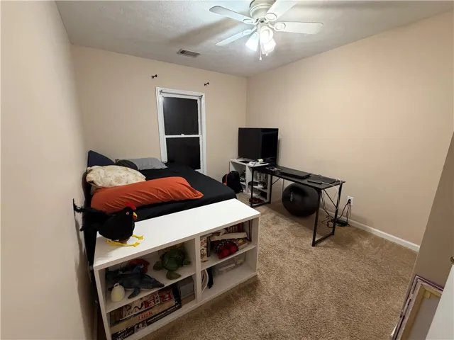 This cozy bedroom provides a comfortable and functional living space.