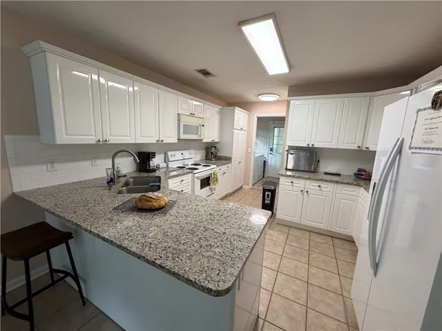 Bright and inviting kitchen with ample counter space and modern appliances.