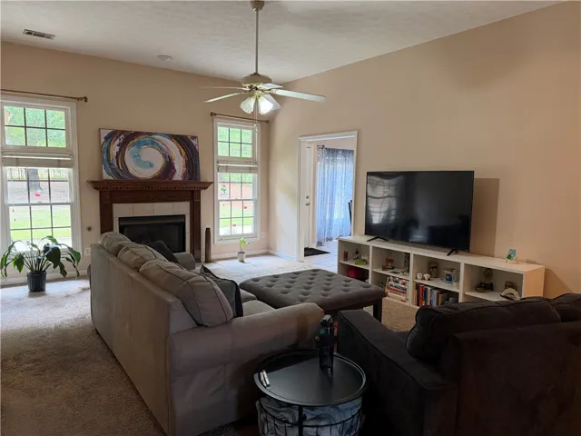This inviting living room features a cozy fireplace and abundant natural light.