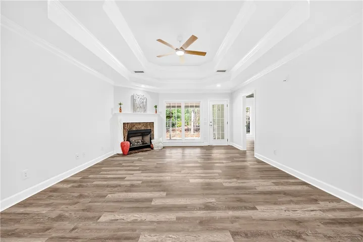 An inviting living room features a fireplace and offers serene views of the outdoors.