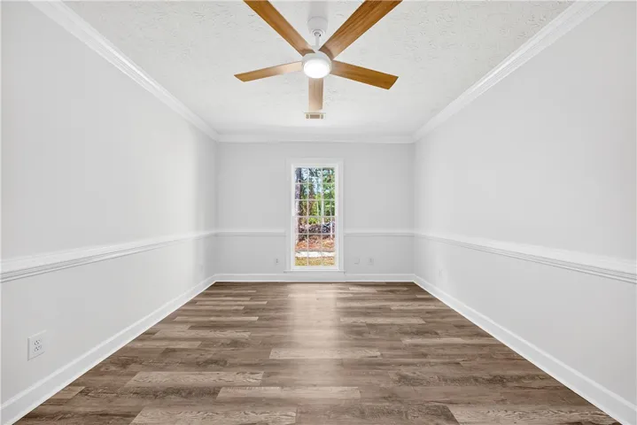 This spacious room features elegant crown molding and durable hardwood flooring.