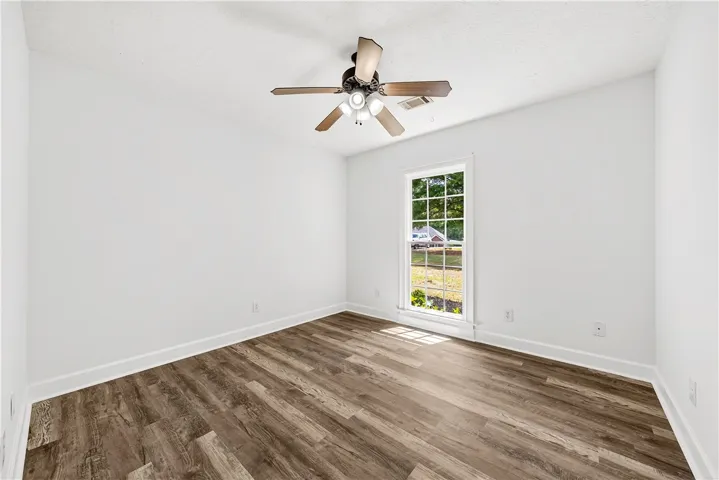 This bright room features a large window, inviting natural light into the space.