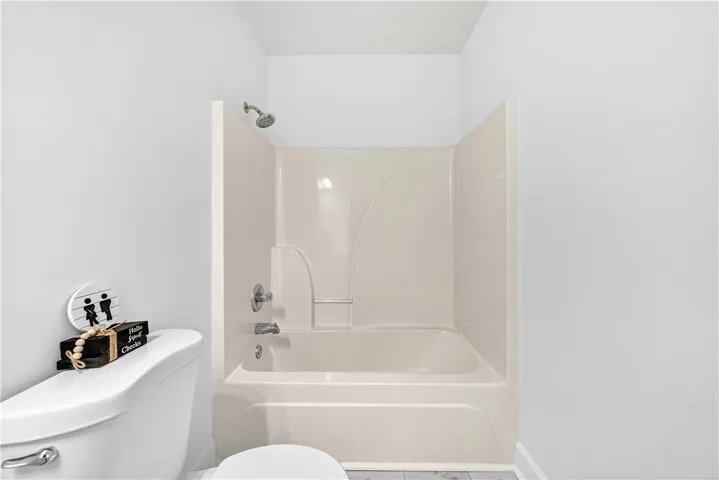 This bathroom features a sleek, integrated shower and bathtub combination.