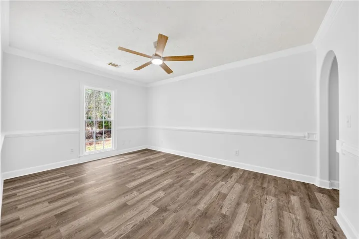 An inviting room features clean lines, ample natural light, and classic architectural details.