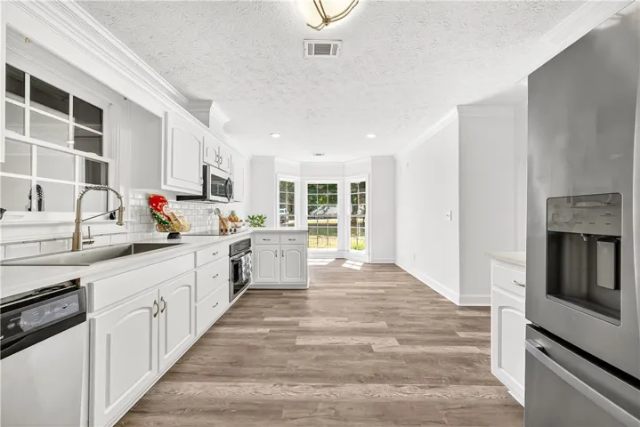 This bright kitchen features modern appliances and ample space, perfect for culinary adventures.