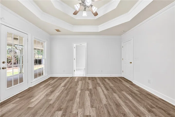 This spacious room features elegant flooring and abundant natural light, offering a versatile living space.