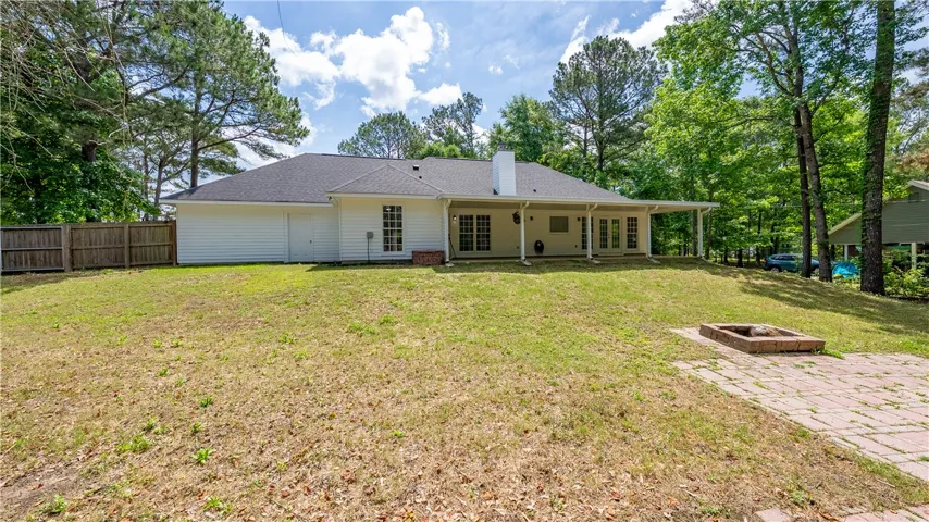 This residence features a private backyard with a patio, fire pit, and ample space for outdoor enjoyment.