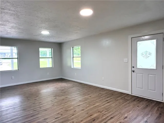 This bright living area features abundant natural light and rich wood flooring.