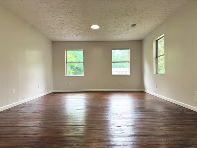 Bright and airy room with gleaming hardwood floors, perfect for any lifestyle.