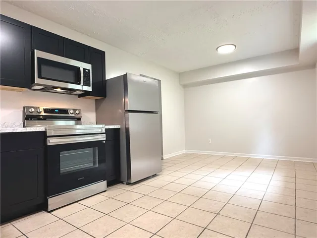 This functional kitchen features stainless steel appliances and ample counter space for daily living.