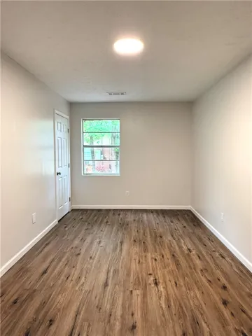 This bright room features durable flooring and ample natural light, ideal for versatile living.