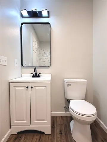 This modern bathroom features a stylish vanity, a sleek mirror, and durable flooring.