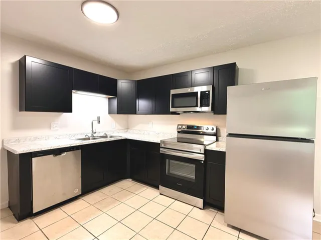 This modern kitchen features sleek cabinetry and essential appliances for comfortable living.