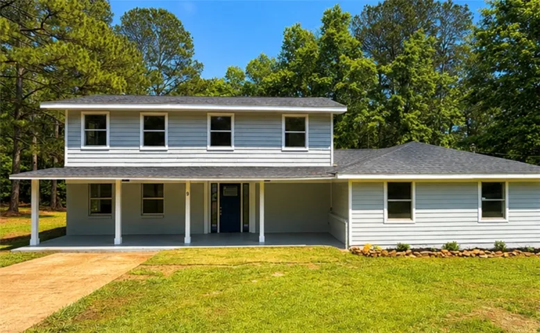 This charming home offers a spacious porch and well-maintained yard, perfect for outdoor living.