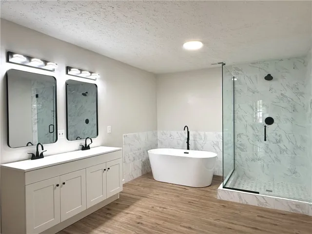 This newly updated bathroom provides a spa-like retreat with modern fixtures and a spacious design.