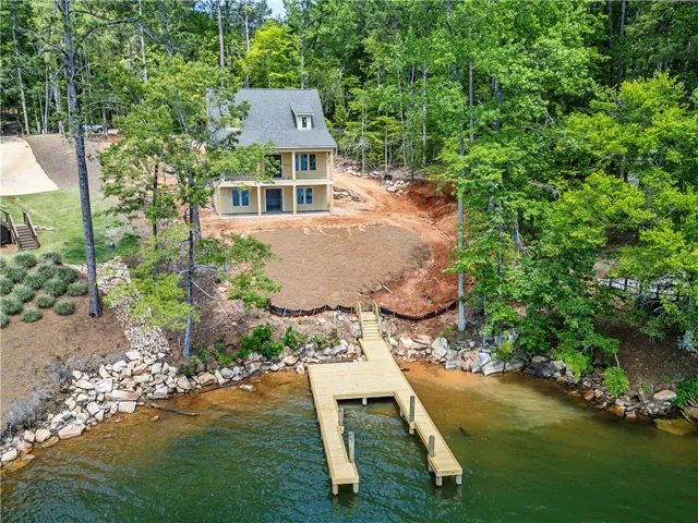 This charming lakeside home features a private dock, offering direct access to tranquil waters.