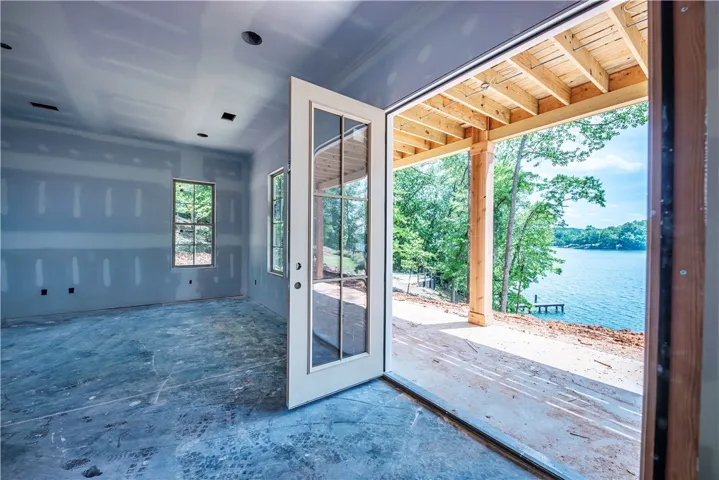 This versatile space opens to a tranquil waterfront view, ready for your custom design.