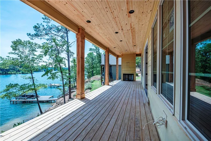 This lakeside deck provides ample outdoor living space with breathtaking water views and a fireplace.