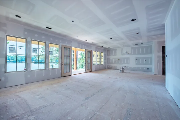 This spacious interior offers lake views, abundant natural light, and direct access to outdoor living.