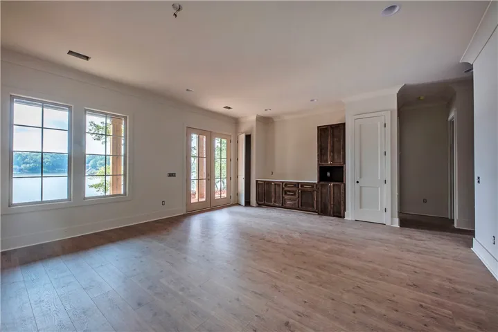 A spacious room with serene water views and custom-built cabinetry for ultimate relaxation.