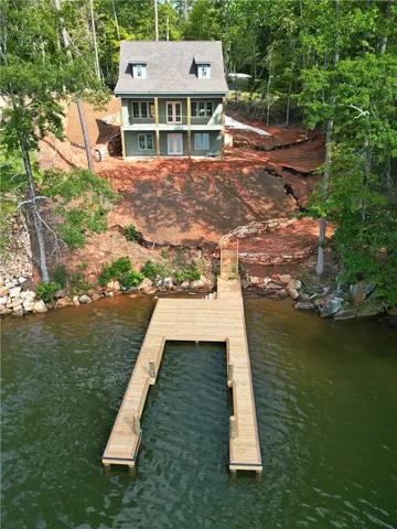 A tranquil lakeside retreat with private dock access and forested surroundings.