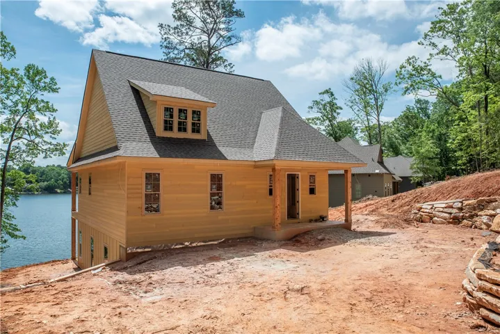 This charming lakeside home offers serene water views and a tranquil natural setting.