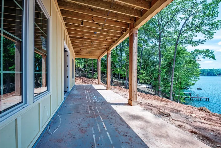This spacious patio offers serene views of the lake, perfect for outdoor living.