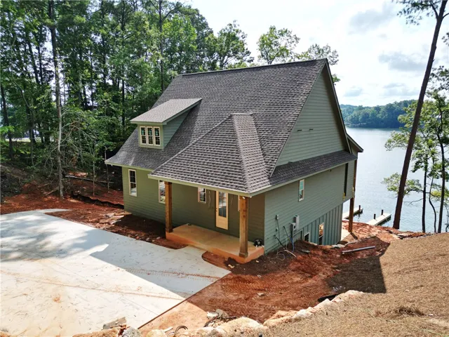 Lakeside home featuring a private dock, offering direct water access and serene views.
