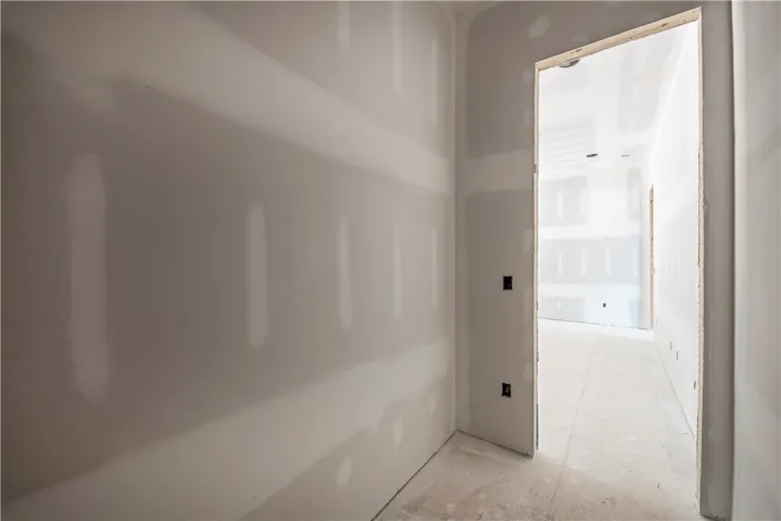 This interior space showcases a new construction with bare walls, ready for personalized finishes.
