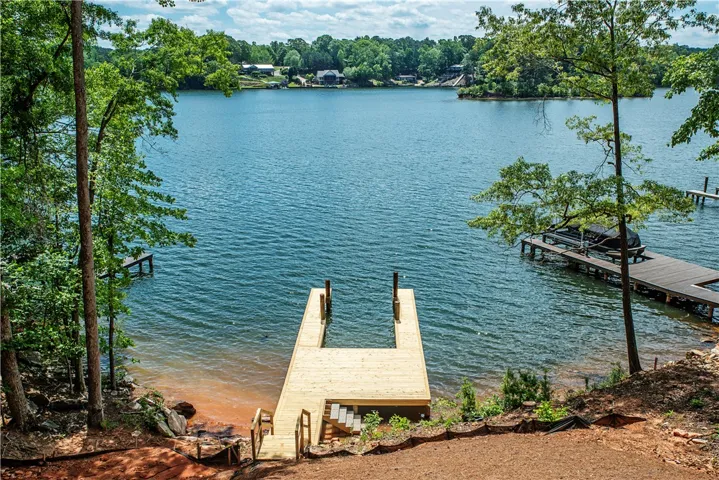 This serene lakeside property boasts a newly constructed private dock for immediate water access.
