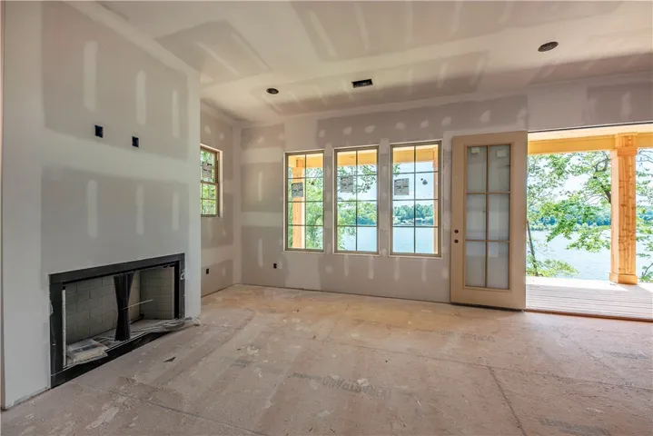 This bright space offers ample natural light and direct access to a deck overlooking the water.