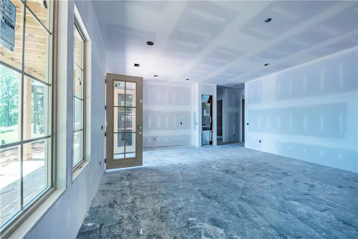 This spacious living area awaits your personal touch with its open layout and abundant natural light.