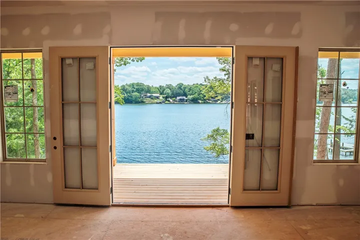 Embrace serene lake views from this expansive open-air deck, perfect for peaceful living.