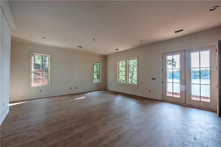 Lakeside views enhance this generously sized room with hardwood floors and ample natural light.