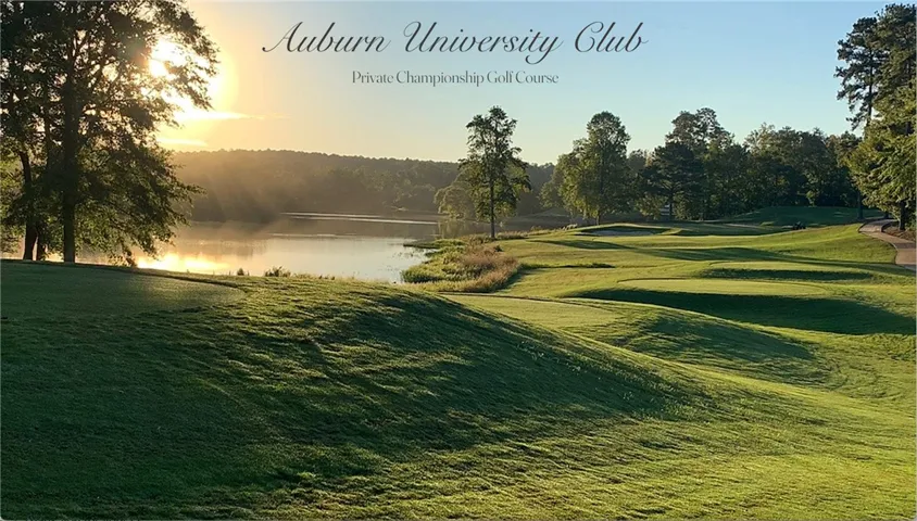 This serene AU Club Member golf course offers picturesque views of the water at sunset.