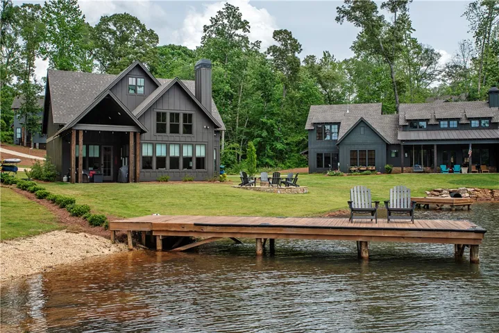 This serene waterfront home features a private dock and ample outdoor space for relaxation.