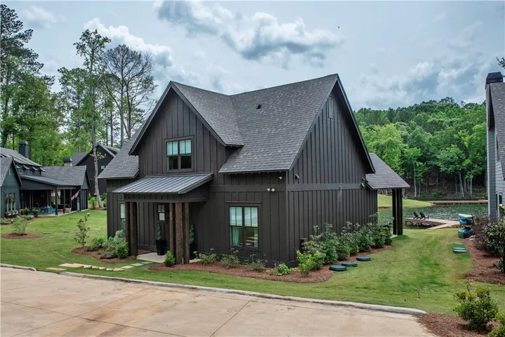 This contemporary waterfront residence offers serene lake views and a private dock.