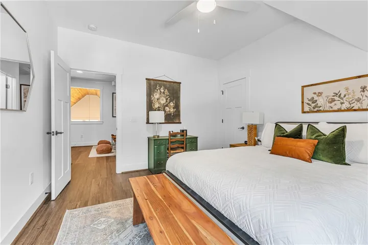 This spacious room features vaulted ceilings, rich hardwood flooring, and ample natural light.