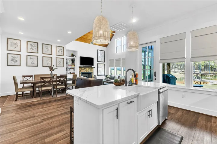 This open concept kitchen flows seamlessly into the dining and living areas, offering expansive views of the lake.