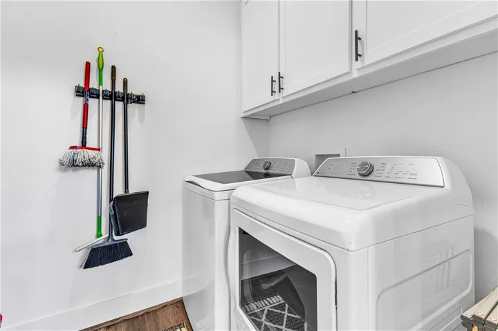 This dedicated laundry space combines modern appliances with smart storage solutions.