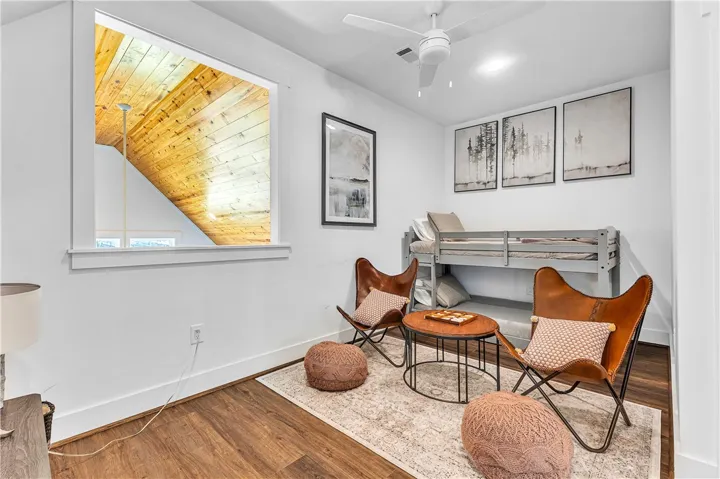 This cozy bedroom features a unique window offering architectural interest and a comfortable setting.