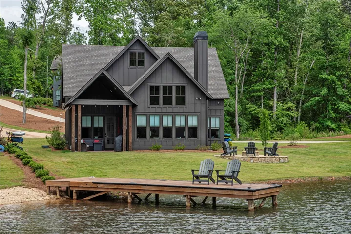 This lakeside home offers serene waterfront living with a private dock and spacious yard.
