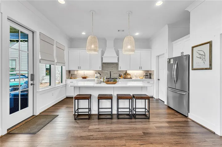 This spacious kitchen offers a large island, stainless steel appliances, and ample natural light.